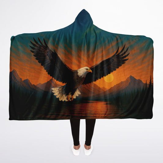 Wings of Freedom Hooded Blanket 45x60 – ultra-soft fleece hooded blanket featuring a majestic bald eagle soaring over mountain peaks and a peaceful sunset landscape, perfect for camping, cabins, and cozy nights