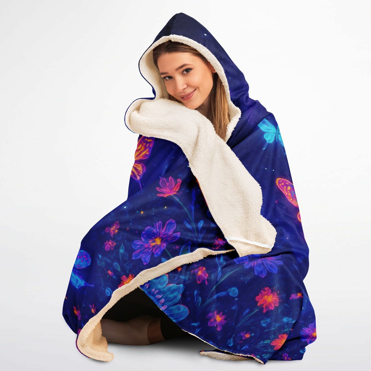 Butterfly Hooded Blanket 45x60 – soft fleece hooded blanket featuring glowing neon butterflies in vibrant blue, pink, and purple tones floating over a cosmic night-sky background full of stars and floral sparkles. Perfect for teens, butterfly lovers, cozy nights, and aesthetic