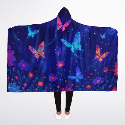 Butterfly Hooded Blanket 45x60 – soft fleece hooded blanket featuring glowing neon butterflies in vibrant blue, pink, and purple tones floating over a cosmic night-sky background full of stars and floral sparkles. Perfect for teens, butterfly lovers, cozy nights, and aesthetic bedroom décor.