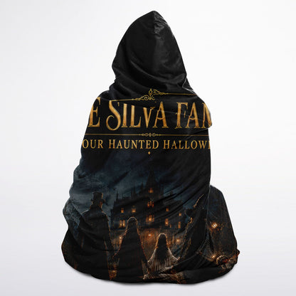 Haunted Family Halloween Hooded Blanket 45x60 – ultra-soft fleece hooded blanket featuring a customizable family walking toward a haunted mansion, cozy