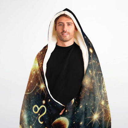 Leo Hooded Blanket 60x80 – oversized sherpa-lined zodiac blanket showcasing an illuminated lion face at the center of a radiant astrological circle, with starbursts, cosmic fire, and celestial symbols glowing across a deep galaxy background. Perfect for cozy nights, meditation, spiritual rituals, and bold Leo