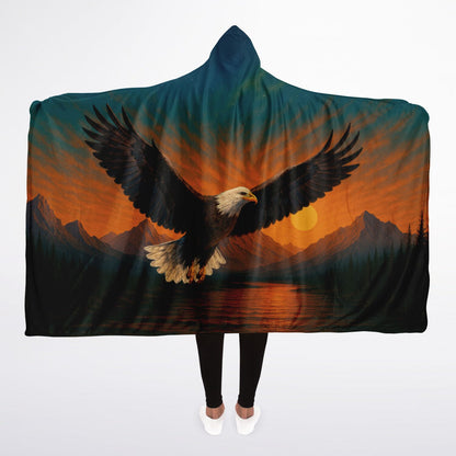 Wings of Freedom Hooded Blanket 45x60 – ultra-soft fleece hooded blanket featuring a majestic bald eagle soaring over mountain peaks and a peaceful sunset landscape, perfect for camping, cabins, and cozy nights
